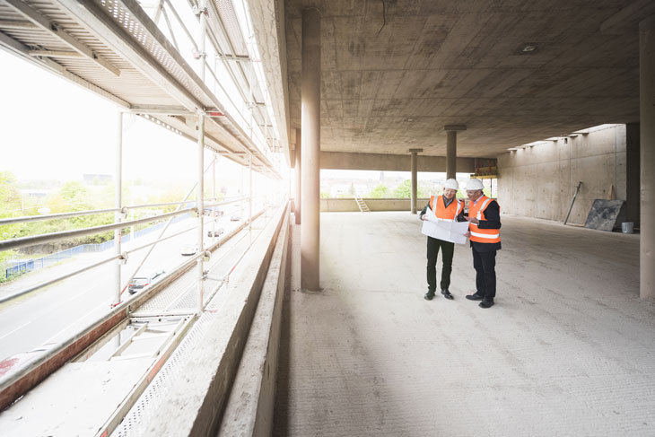 auditors-checking-plans in building construction